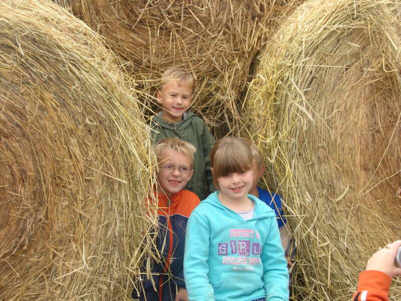Kids com ing out of the hay tunnel
