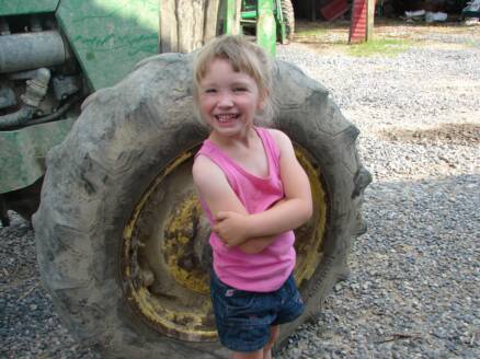 Abby standing with tractor